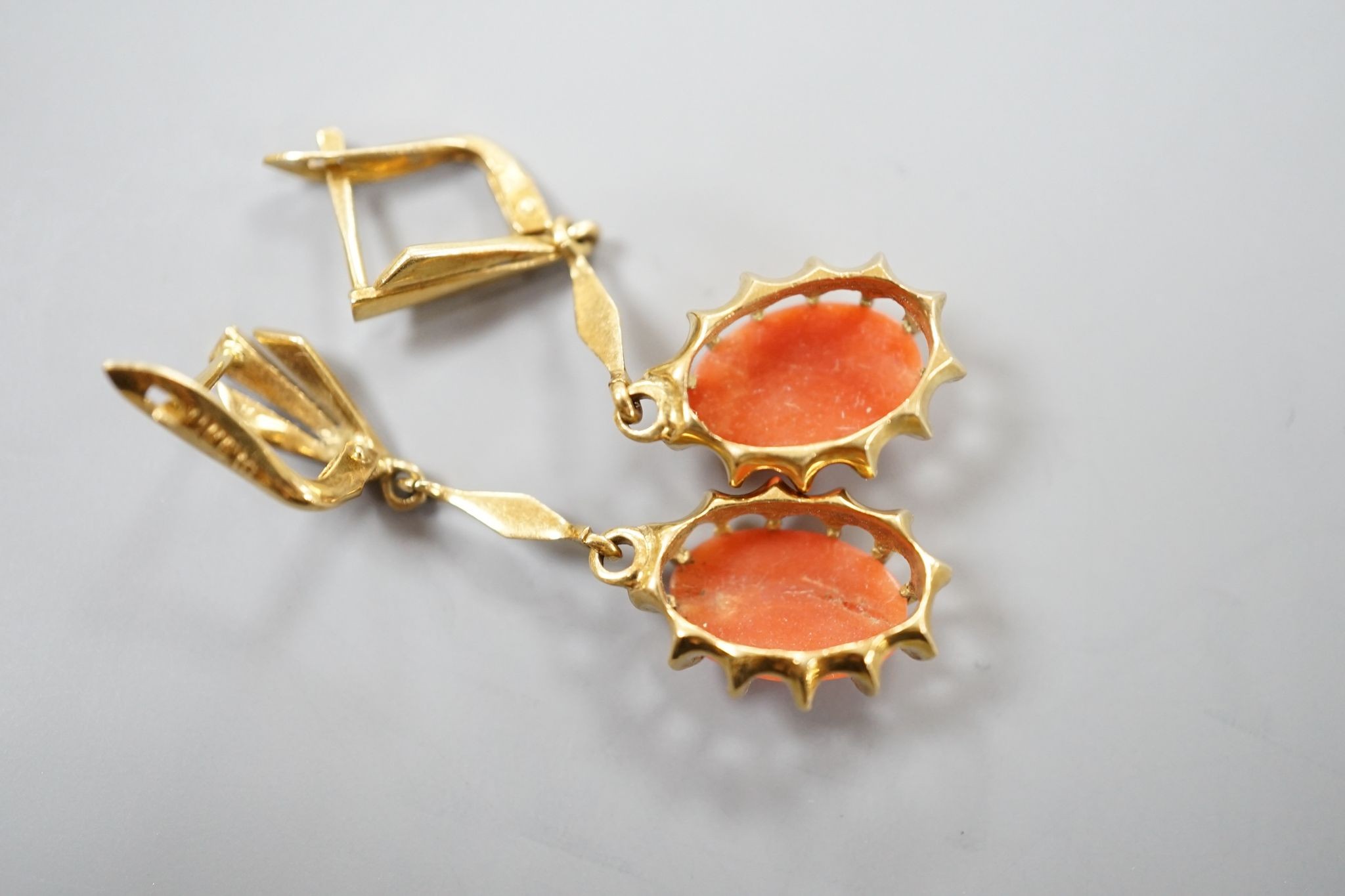 A pair of 18k and oval coral bead set drop earrings, 39mm, gross weight 6.8 grams.